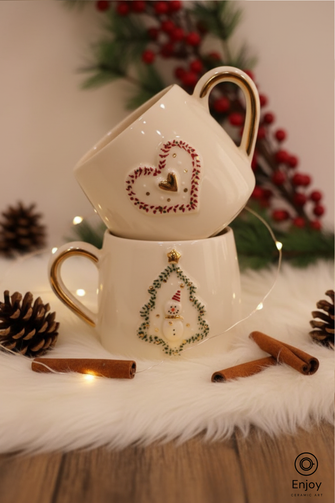 Decorative teacup set with Christmas-themed designs on a white surface with pinecones and cinnamon sticks.