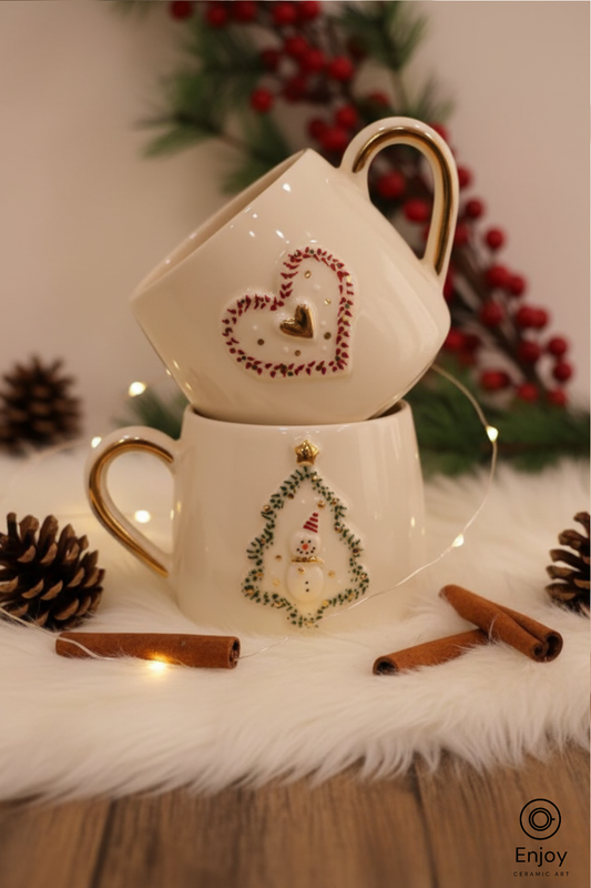 Decorative teacup set with Christmas-themed designs on a white surface with pinecones and cinnamon sticks.