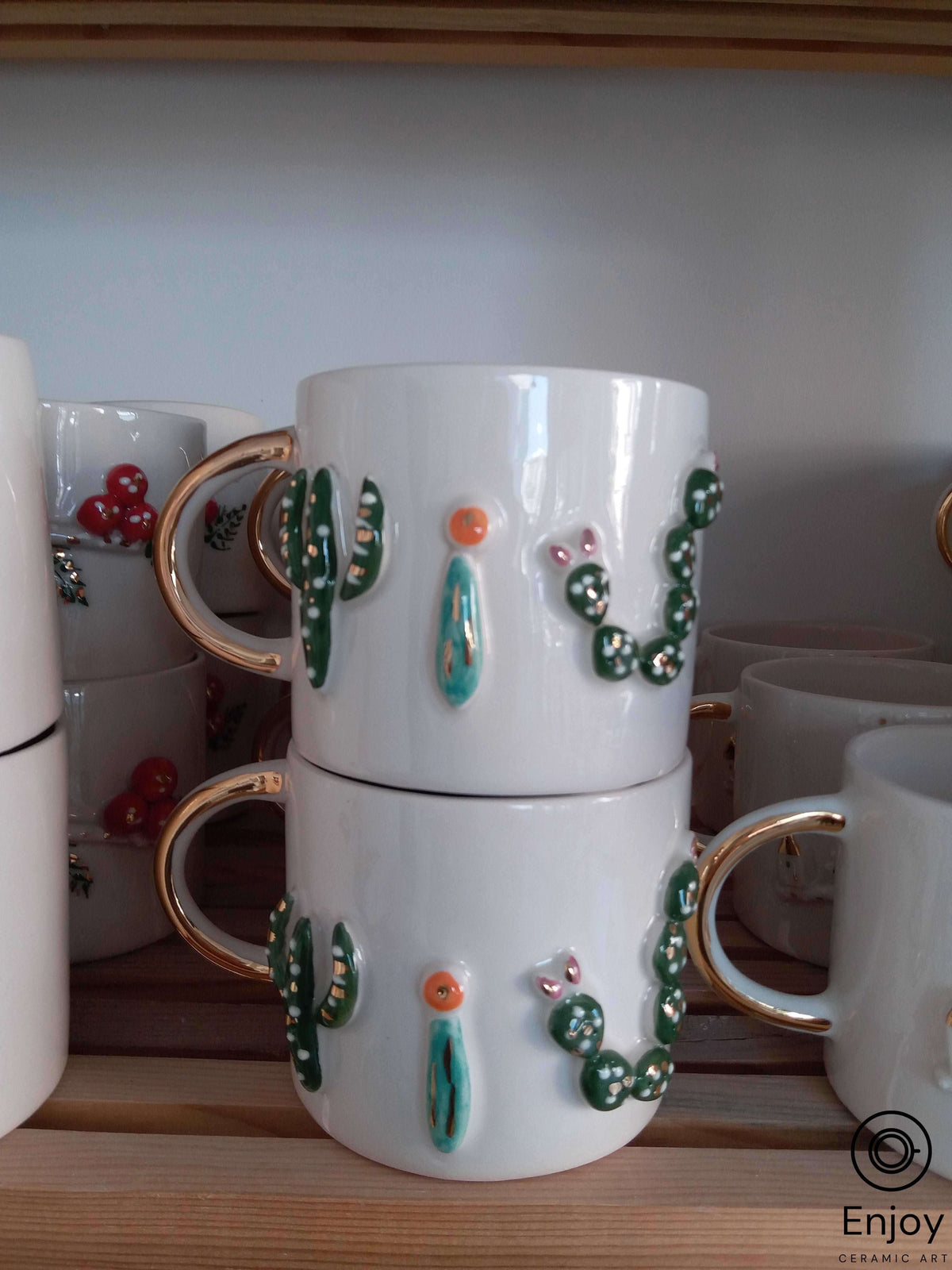 Stackable Mug Set Cactus Stacked white mugs with gold handles, adorned with 3D cactus designs ...