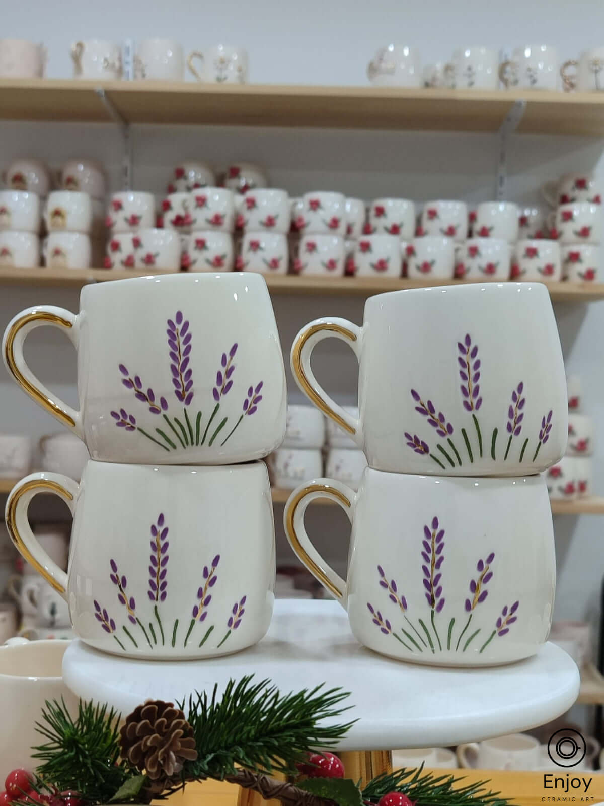 Set of four handmade ceramic mugs featuring a gentle lavender design, accentuated with golden handles, evoking a serene and natural touch to your drinkware collection. Perfect for a cozy gathering or as a thoughtful gift.