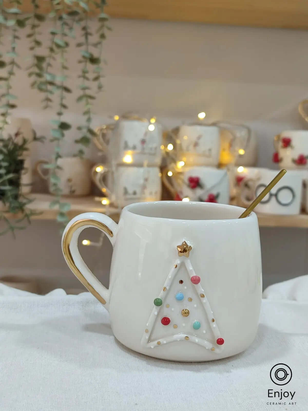 A handmade Star Trek-inspired ceramic Christmas mug featuring a 3D Christmas tree with colorful baubles, a gold star, and a gold handle, perfect for Trekkie fans.