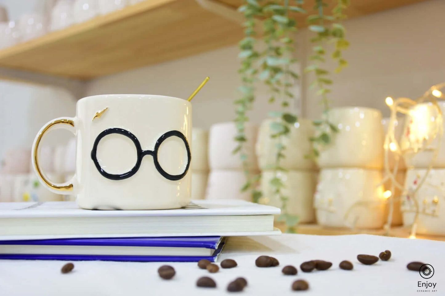 A whimsical ceramic mug with round glasses and a gold lightning bolt design, sitting atop books with scattered coffee beans, creating a magical vibe.